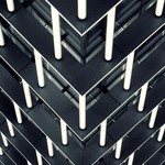 Symmetrical view of modern architectural building with geometric pattern and steel design.